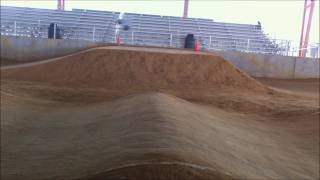 RC Traxxas EMAXX Brushless Jumping on Hard Packed Dirt BMX Race Track [upl. by Ahsikrats]