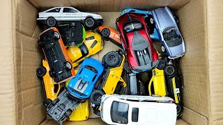 Box full of various miniature cars Peugeot Jaguar Pagani Hyundai Cadillac One Opel DHL [upl. by Donni]