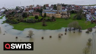 UKs Tewkesbury Abbey turned into an island as flood water streams off the Malvern Hills  SWNS [upl. by Yddeg]