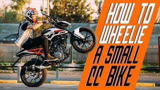 How to wheelie a small cc bike  RokON VLOG 25 [upl. by Scharaga]