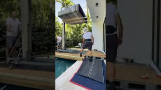 How to hoist a steel and wood bookcase with equipment over a swimming pool [upl. by Akenet]