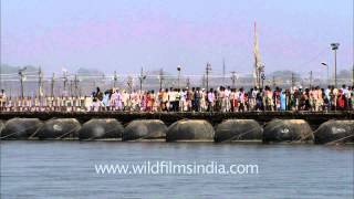 Pilgrims crossing the River Ganges on a pontoon bridge [upl. by Norvall227]