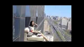 Woman sunbathes while hanging out of 23rdfloor window [upl. by Maje650]