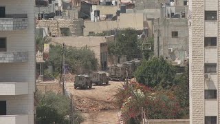 Israeli military vehicles seen moving in Jenin West Bank and helicopters overhead [upl. by Nilekcaj]