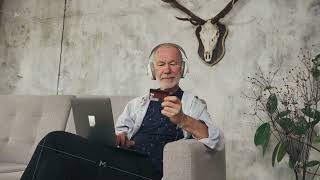 Old man making online payment with bank card using modern laptop at home on sofa [upl. by Moazami]