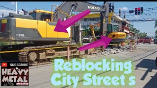 excavator  Reblocking city streets [upl. by Yurt]