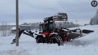 Huddig backhoe loader works with electricity poles in snowy terrain [upl. by Noskcaj]