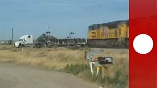 Dramatic footage Train hits trailer truck stuck on tracks Holy smokes says witness [upl. by Lehcor]