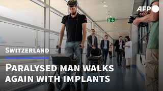 Paralysed man walks again via thoughtcontrolled implants  AFP [upl. by Arriec992]