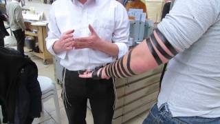 Putting on tefillin phylacteries including an explanation The Western Wall Jerusalem [upl. by Harold]