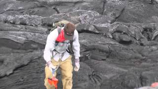 Geologist collects a fresh lava sample in Hawaii in May 2014 [upl. by Allicirp]