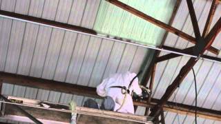 Closed cell Spray foam insulation being applied to a auto shop [upl. by Ocirled830]