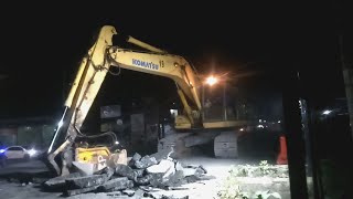 Breaker Komatsu excavator works to crush and collect asphalt fragments [upl. by Yrelle]