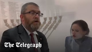 Polish MP uses fire extinguisher to snuff out Jewish menora in parliament [upl. by Eerehc847]