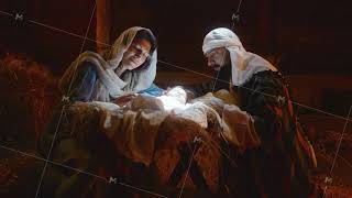 Mary and Joseph caressing baby Jesus in illuminated manger [upl. by Aesoh]