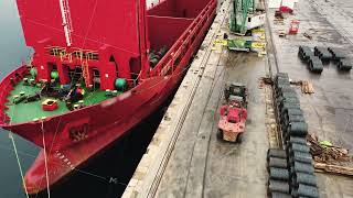 Aerial view of the process of loading a ship in a sea river port Freight ship on the berth [upl. by Valora380]