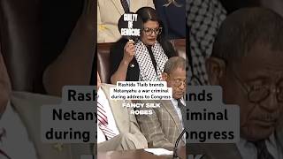 Democrat Rashida Tlaib holds sign accusing Netanyahu of genocide during Congress address [upl. by Aneehsor336]