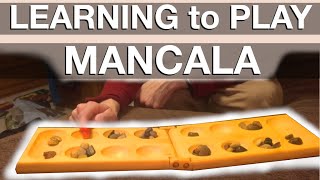 Learning how to play Mancala [upl. by Ecinnahs]