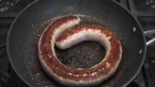 Traditional Cumberland Sausage sizzling in a pan [upl. by Adierf]