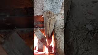 Thermal mass rocket heater air draw through the system wood smoke closeup near the end [upl. by Bullock]