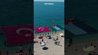 Divers unfurl Turkish and Palestinian flag in Antalya beach [upl. by Odlaniger]