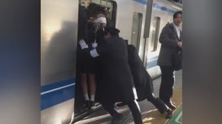 Professional Pushers Shove Passengers Onto Busy Tokyo Train [upl. by Norrehc390]