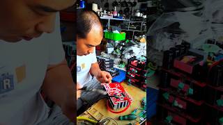 Repairman repairing electrical appliances with soldering iron and tin solderingshorts [upl. by Sadick]