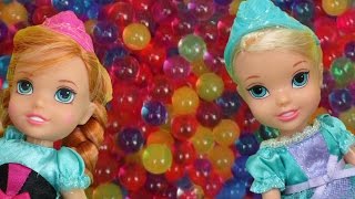 Elsa and Anna toddlers have fun in ORBEEZ  They slide into colorful water beads [upl. by Rama]