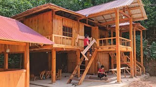 The girl builds the inside of the log house using assembled wooden bars to make a bed frame [upl. by Oletta]