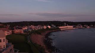 Aerial sunset coastline view of Ogunquit Maine USA drone revealing waterfront homes and resorts [upl. by Fast145]