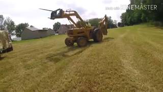 Ford 4400 tractor loading round bales of hay [upl. by Drarreg]