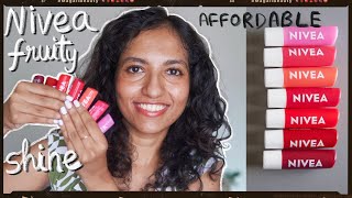 Nivea fruity shine lip balm swatch  review 🍇🍒🍉 affordable  Indian  brown skin friendly [upl. by Nerita459]