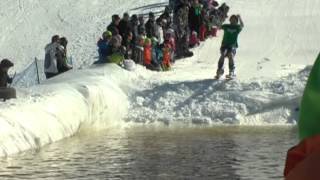 People skiing and snowboarding across water [upl. by Fanni]