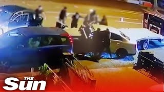 Massive gang of thugs smash up car with baseball bats in Birmingham [upl. by Airdnahs]