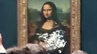 Climate protester throws cake at Mona Lisa painting [upl. by Schonfield]